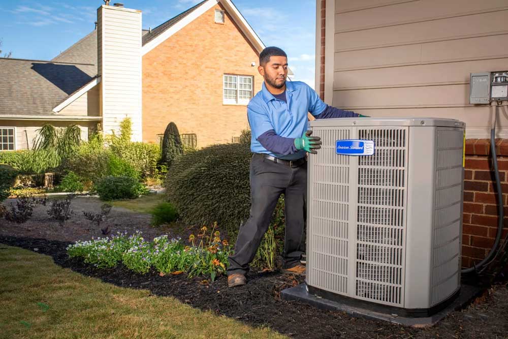Technician installing American Standard unit