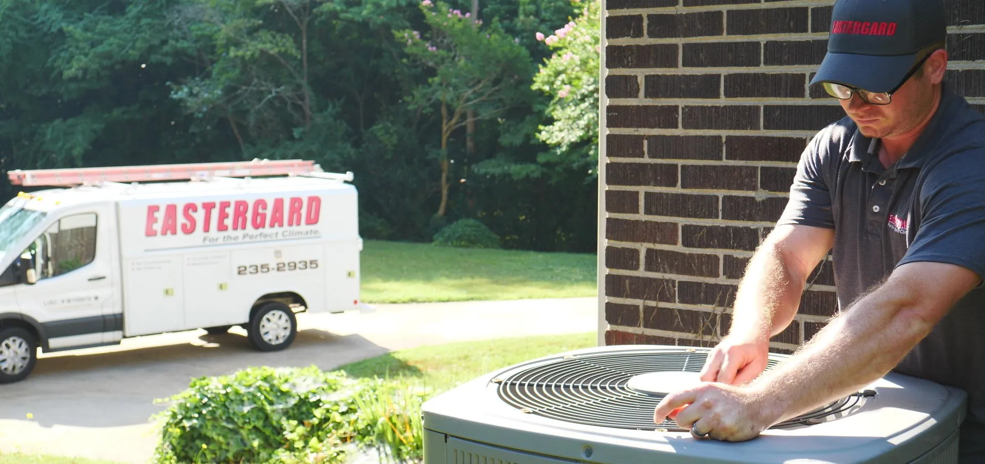 Eastergard HVAC technician working on an outdoor AC unit