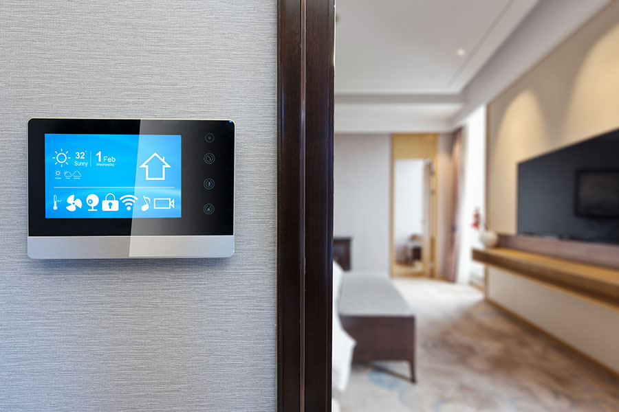 Wall-mounted smart thermostat installation with touchscreen display controlling temperature