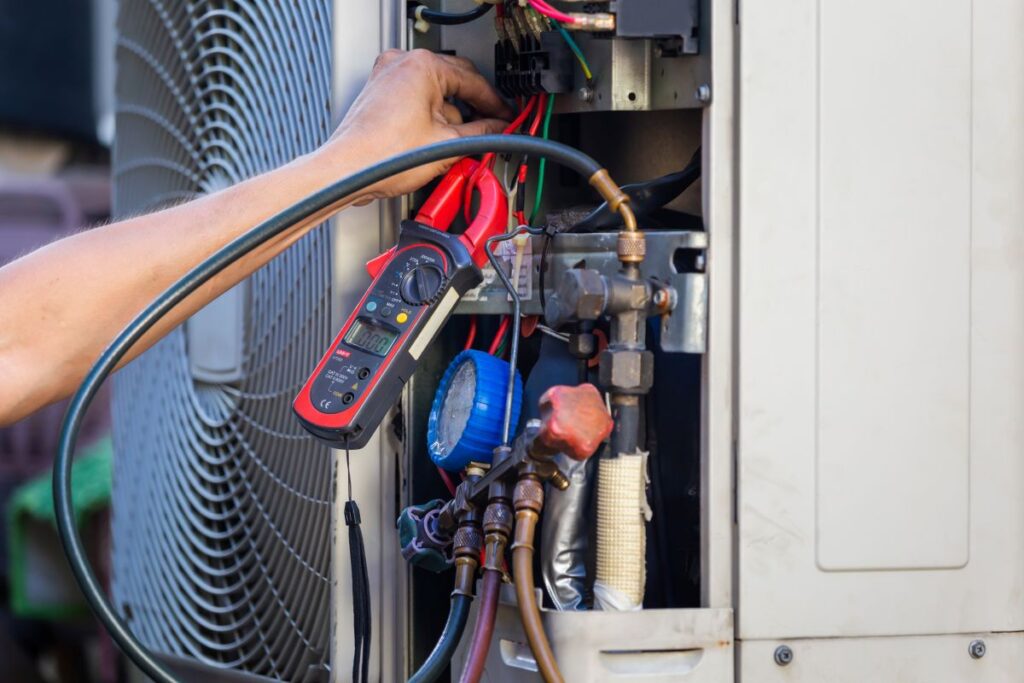Air Conditioning Repair man hands checking and fixing modern air conditioning system