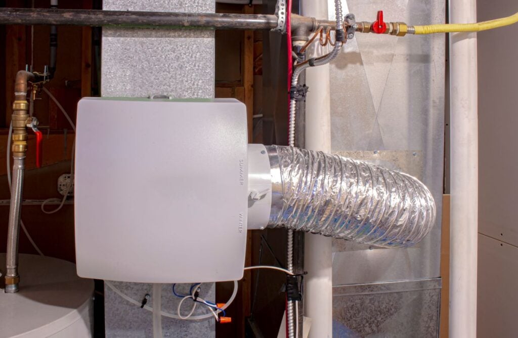 A home humidifier attached to the return duct with a bypass connection to the supply hot air duct