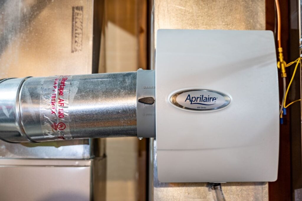 Whole house humidifier attached to HVAC heating duct