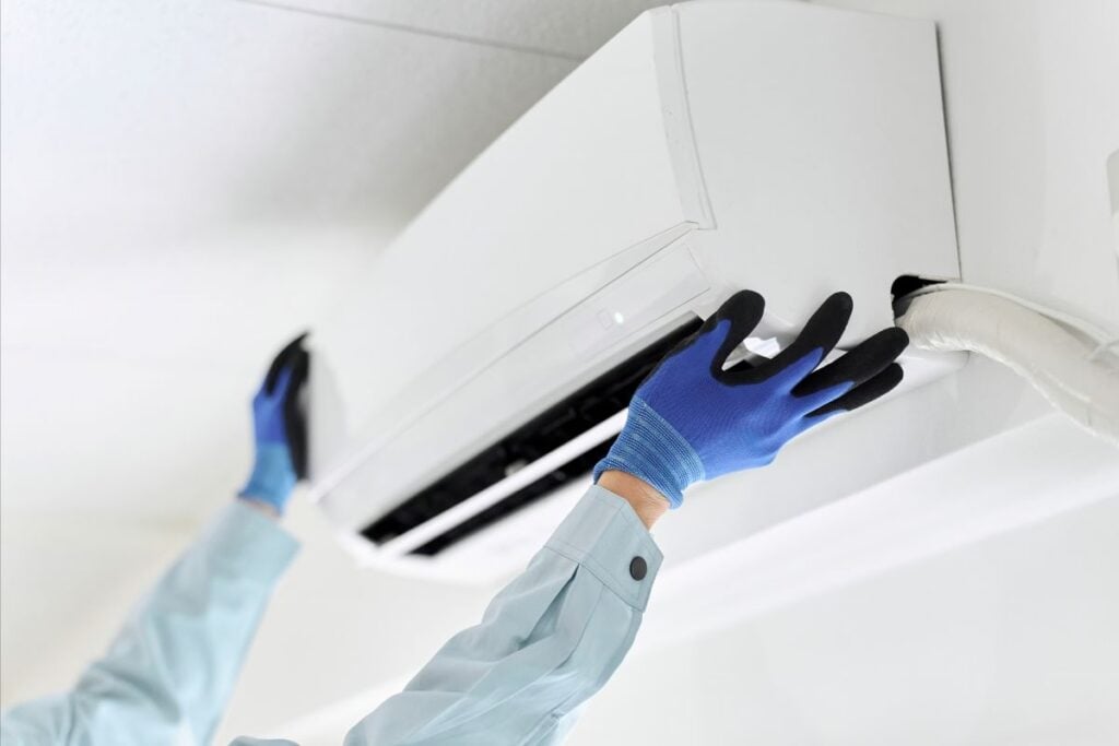 hands-installing-an-AC-unit-on-the-wall