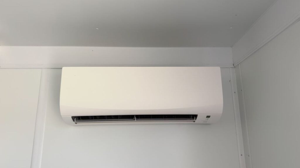 A modern white ductless mini-split air conditioner mounted on a wall

