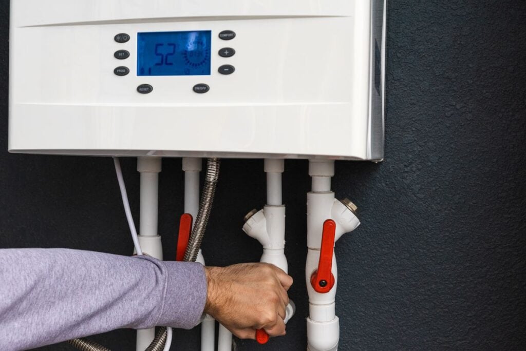 Hand installing tankless water heater