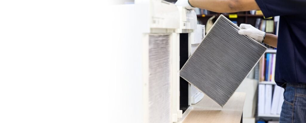 Technician open cover to fix and holding dirty and dust air purifier filter for removing and change.