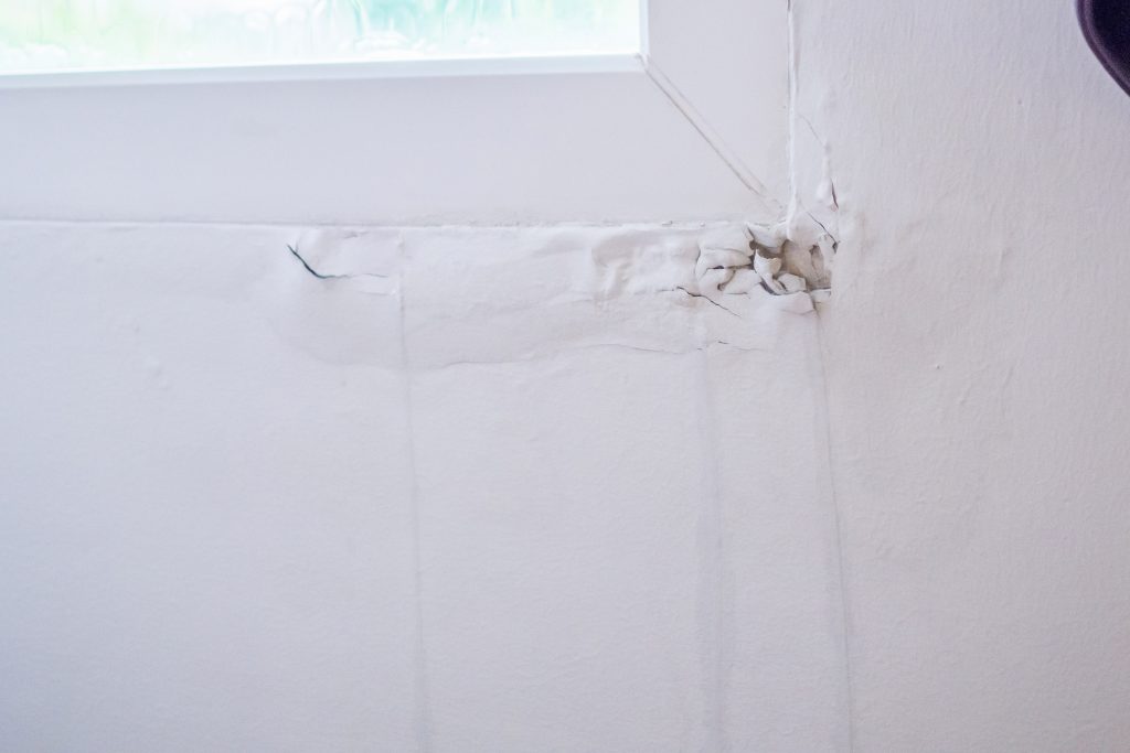 hvac zoning system house wall near the window with some water stain show peeling paint