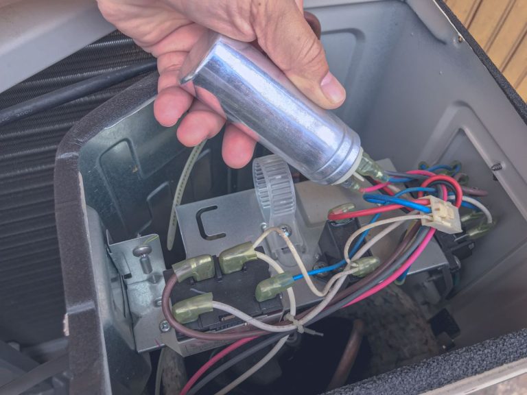 man holding ac capacitor